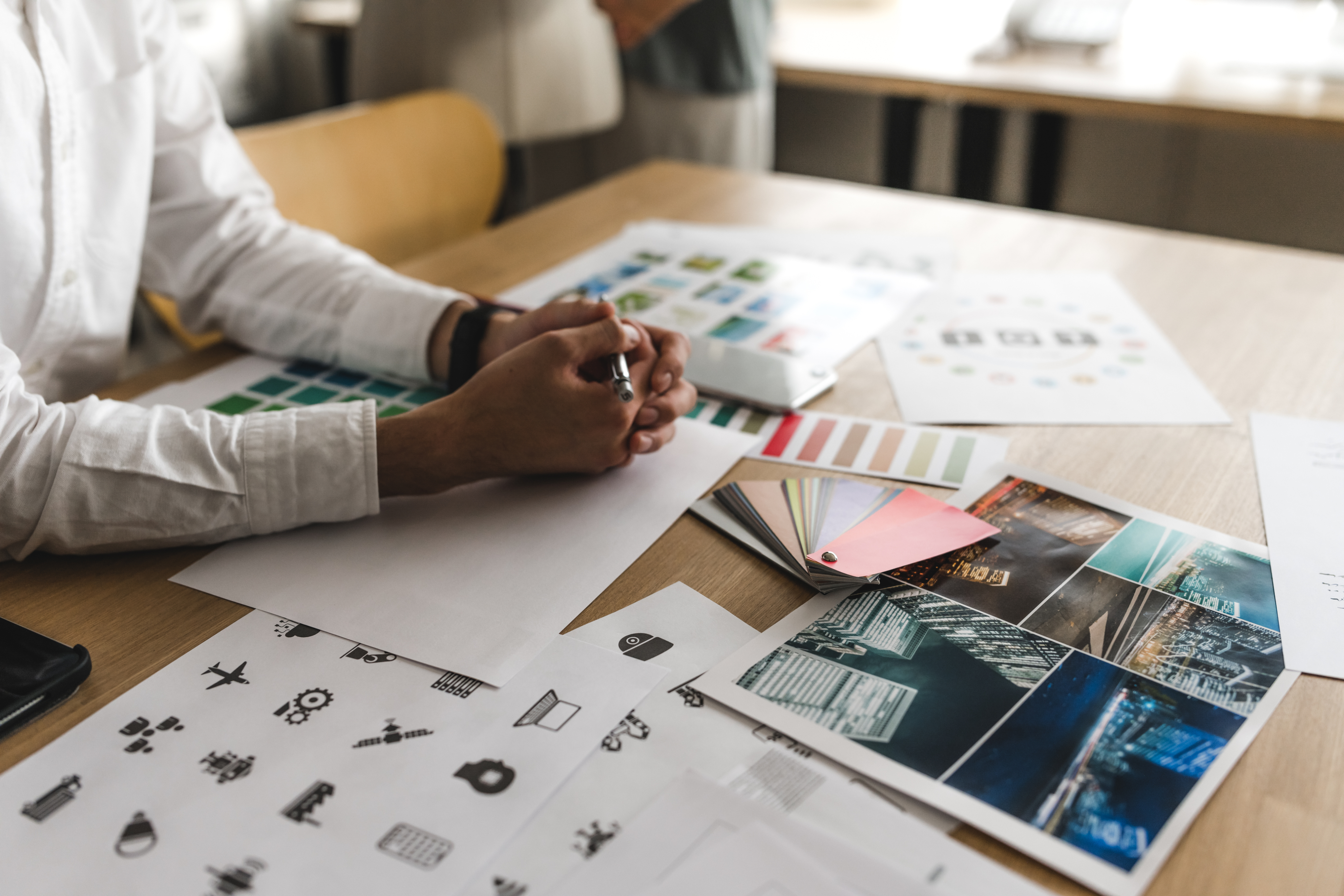 Photo of rows of books in a library with marble busts.